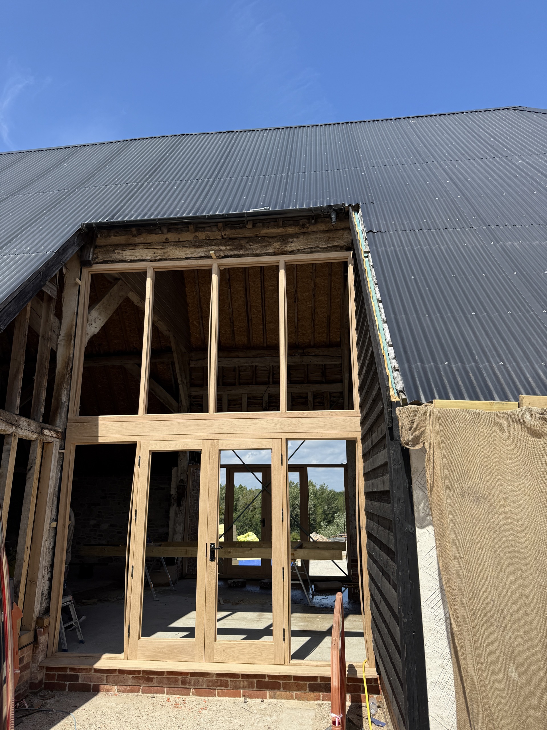 Large oak frame installed within the existing building opening