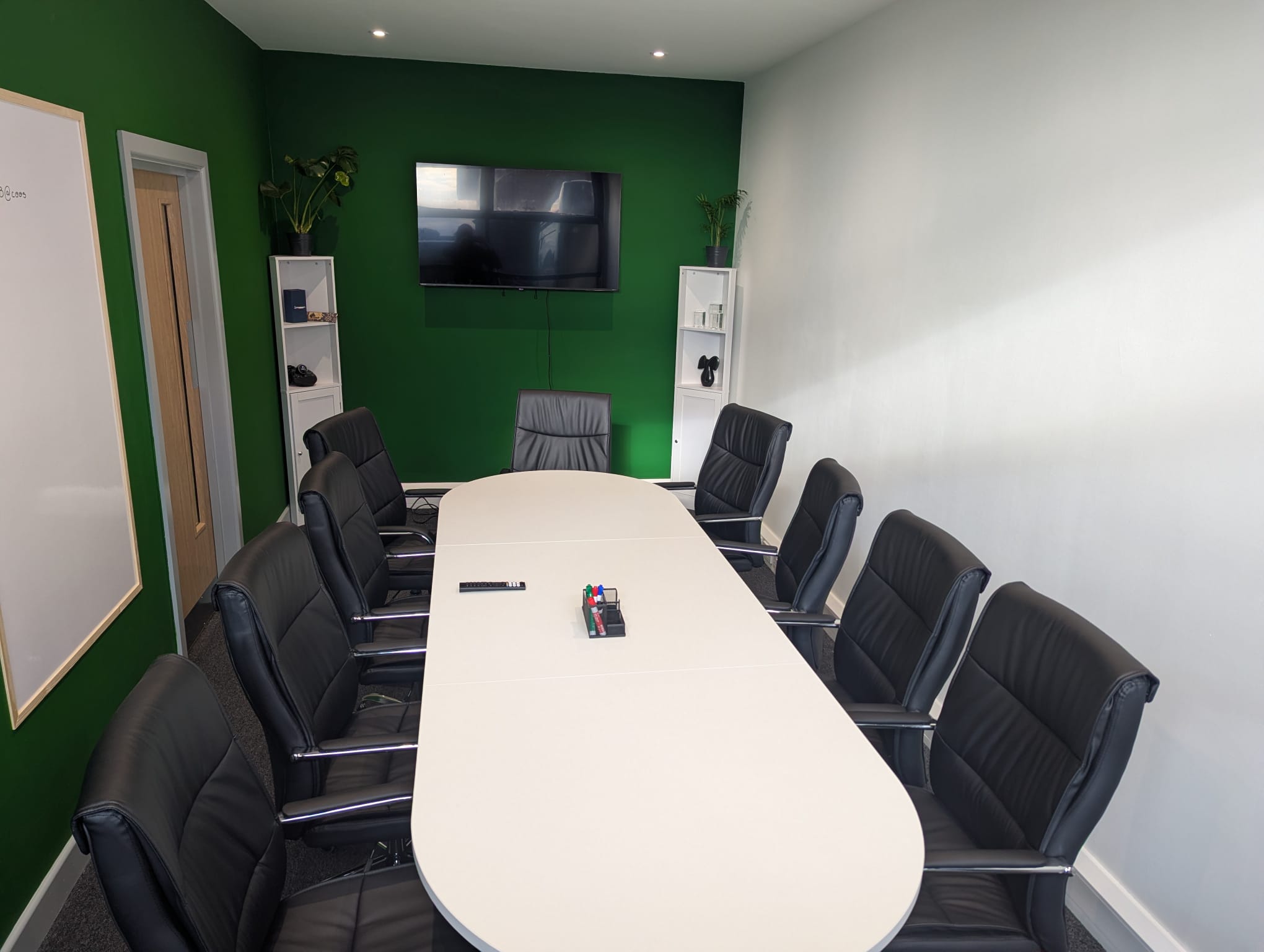 Completed WAER meeting room with timber door and green feature wall