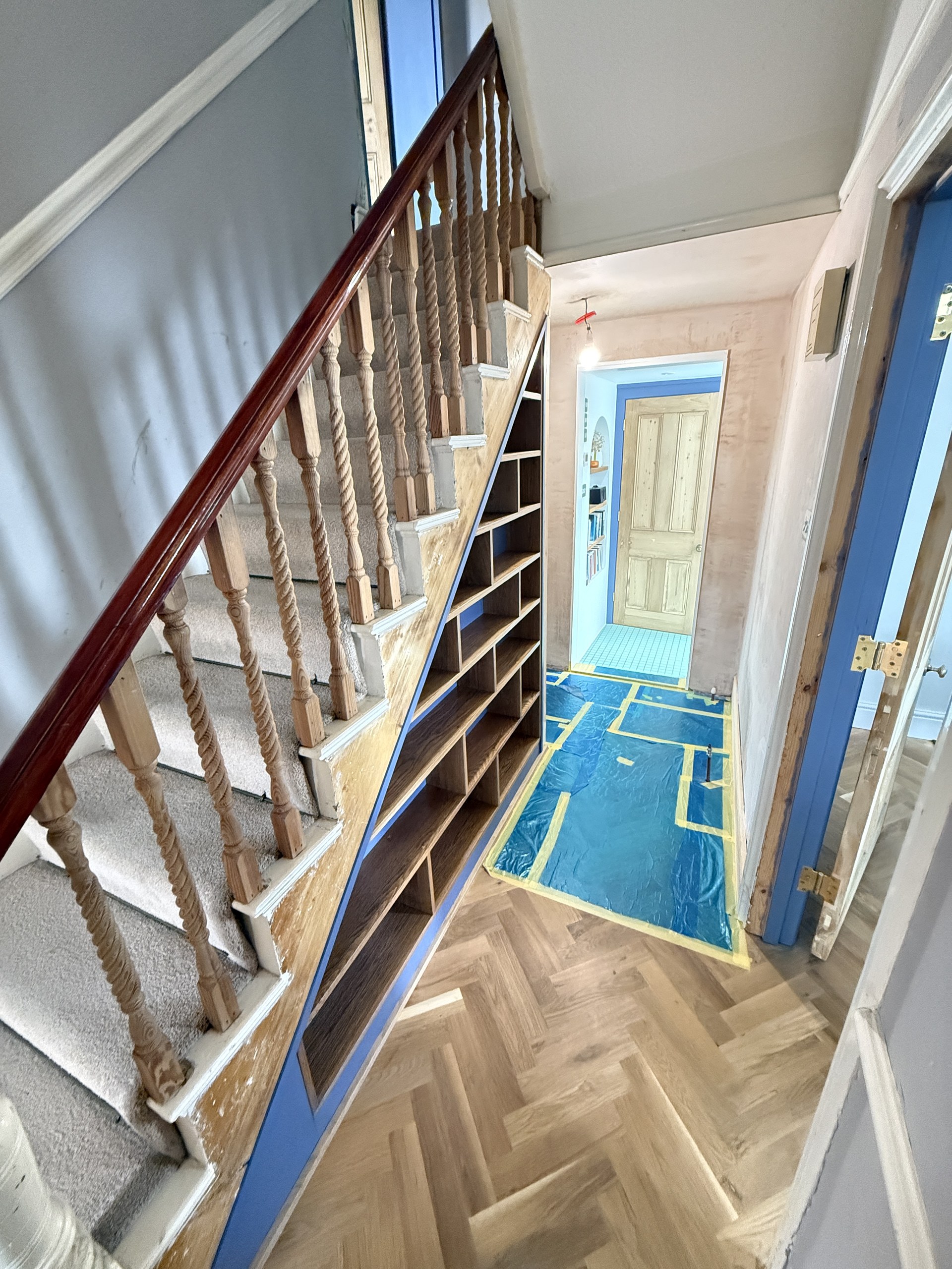 Wide view of the new under-stair shelving unit with the adjacent stair and hallway in Worthing